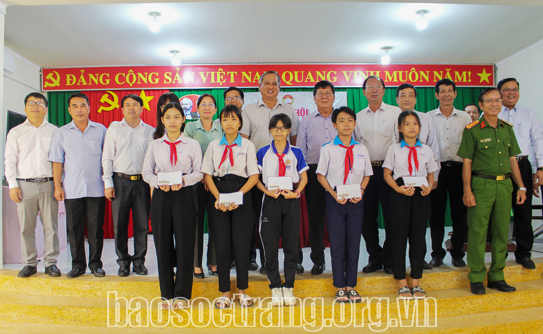 Lãnh đạo tỉnh, huyện trao học bổng cho các học sinh nghèo vượt khó học tập. Ảnh: SỚM MAI